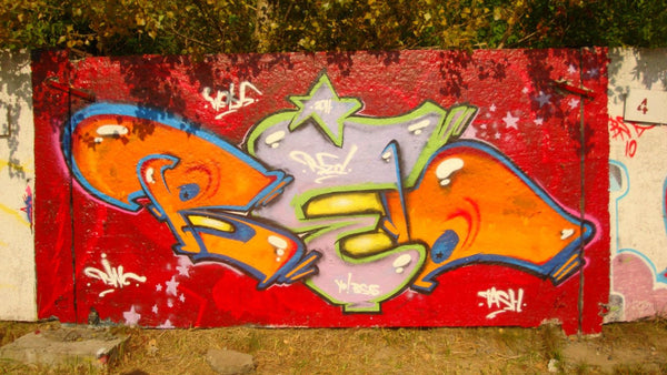 Colorful graffiti piece by RED crew — RING, WEKX and TASH — orange letters on red background with lilac stars, 2011